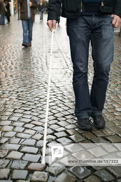 Blind man using a cane