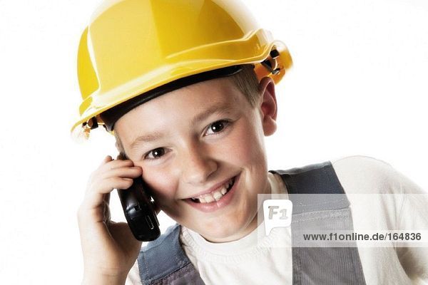 Boy wearing helmet  using mobile phone