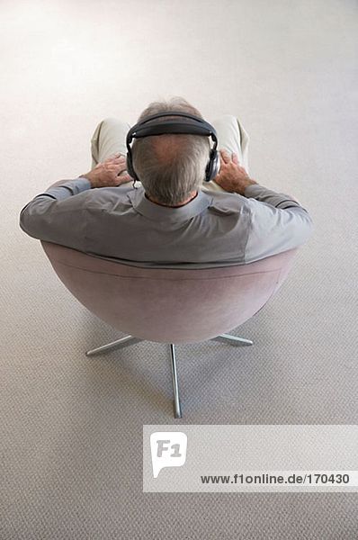 Rear view of man wearing headphones