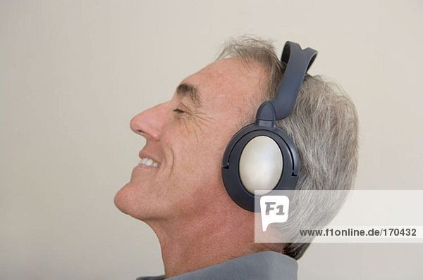 Mature man wearing headphones