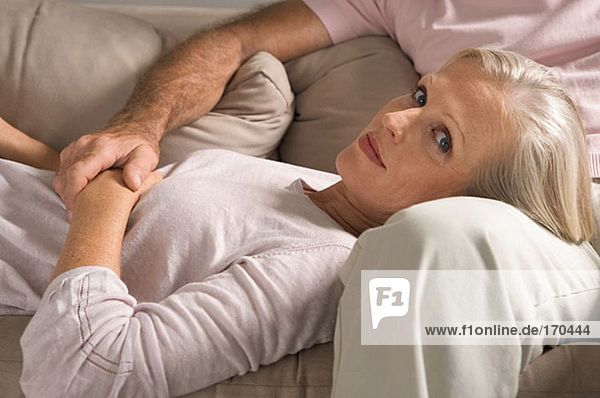 Woman lying in man's lap