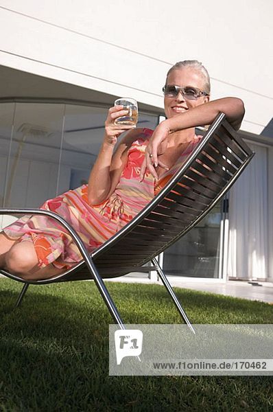 Mature woman in lounge chair