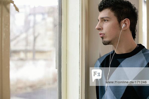 Man listening to music and looking wistful