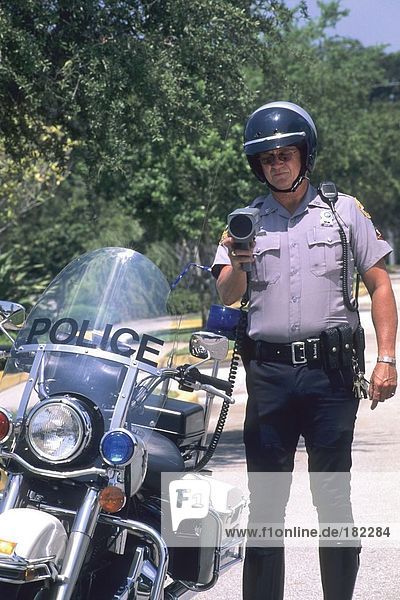Policeman standing near motorcycle