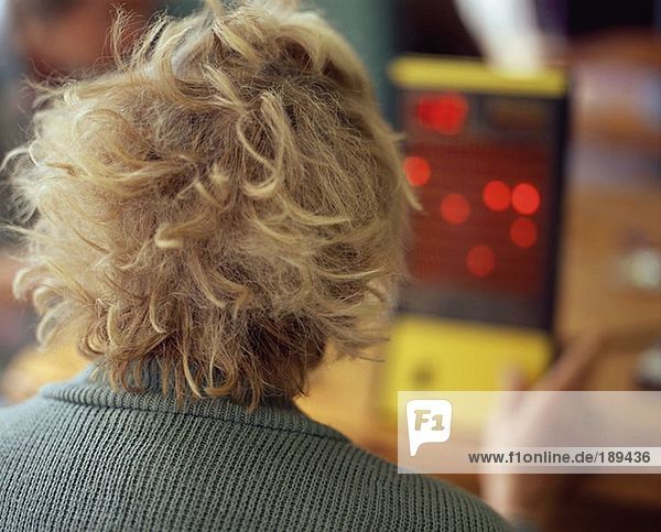 Elderly woman using electronic bingo machine
