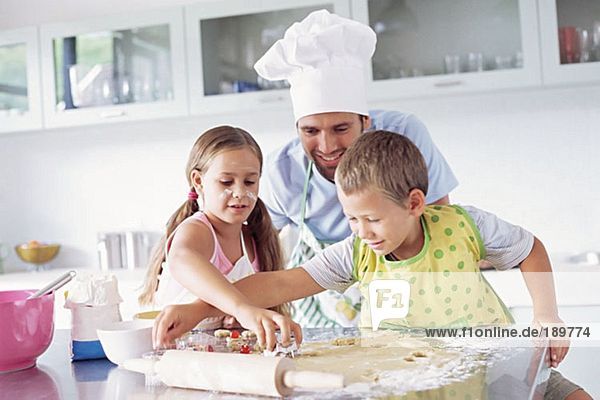 Father and children baking