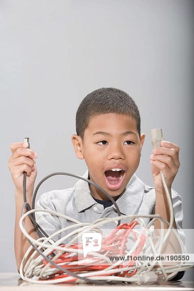 Boy with tangled cables