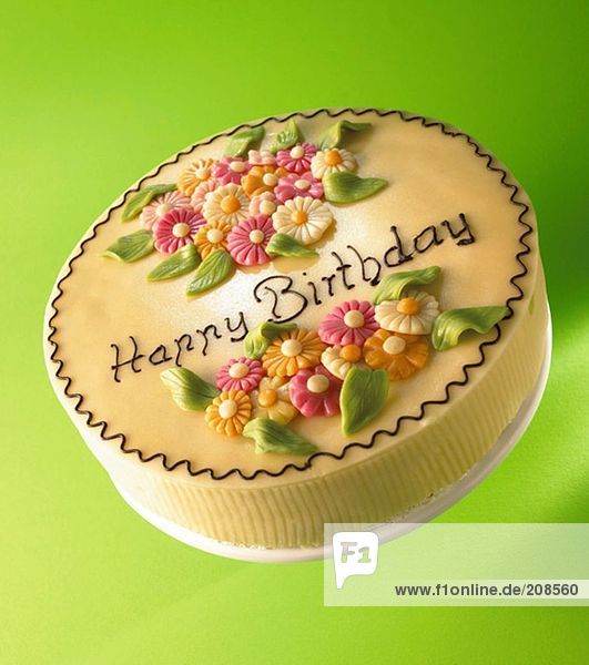 Torte mit Marzipanblumen und Aufschrift Happy Birthday