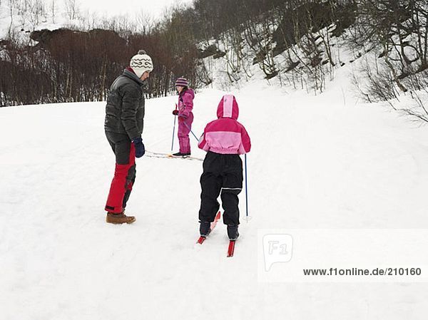 Mother and daughters skiing