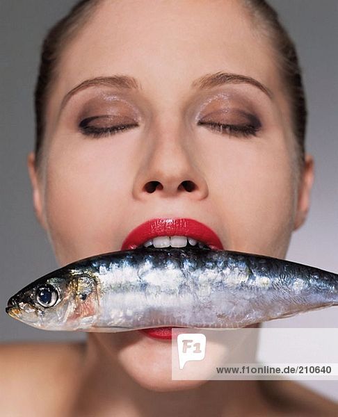 Frau mit Fisch im Mund