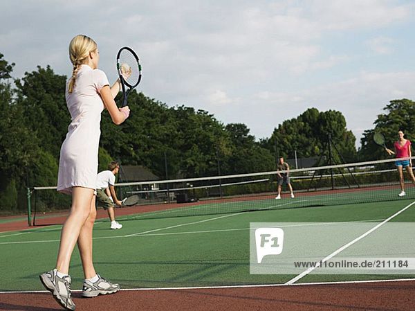 Young people playing tennis