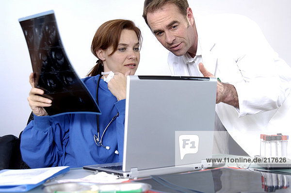 Two doctors looking at laptop