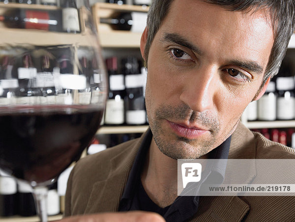 Man holding glass of red wine