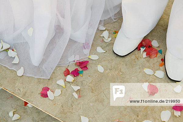 Konfetti rund um die Füße von Braut und Bräutigam