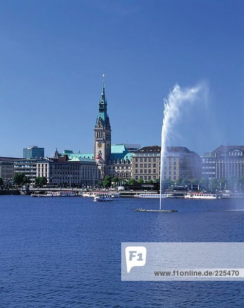 Fountain in lake against buildings in city  Alster Lake  Binnenalster Lake  Hamburg  Germany