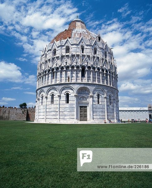 Domed building against sky on grassy landscape  Pisa  Tuscany  Italy