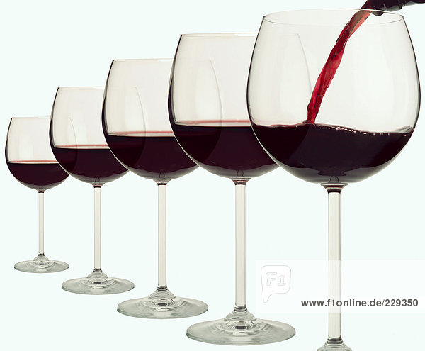 Fünf Rotweingläser in einer Reihe