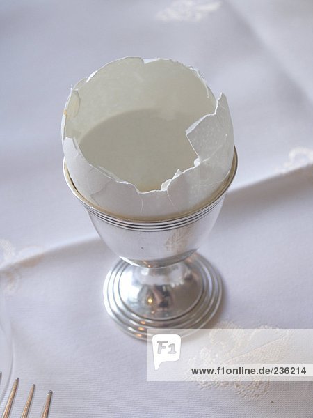 Empty eggshell in silver eggcup