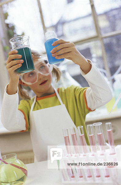 Mädchen (8-9) im Chemielabor mit Schutzbrille