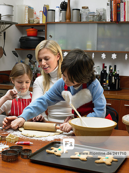 Mutter und Kinder machen Kekse