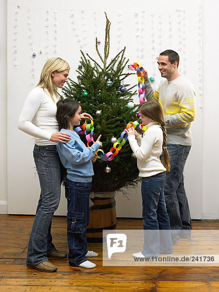 Family decorating christmas tree