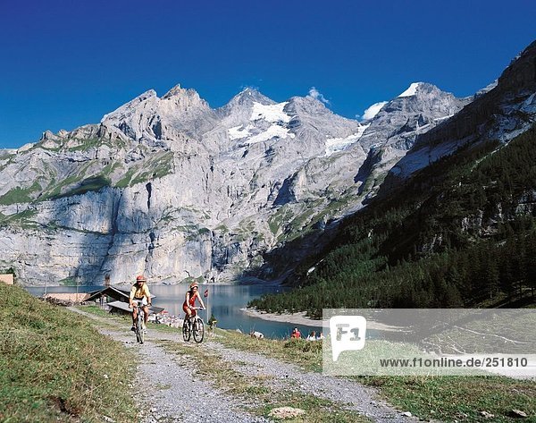 10422320  riding a bicycle  biking  riding a bike  bicycle  bike  biking  sport  Alps  mountains  rocks  cliffs  canton Bern