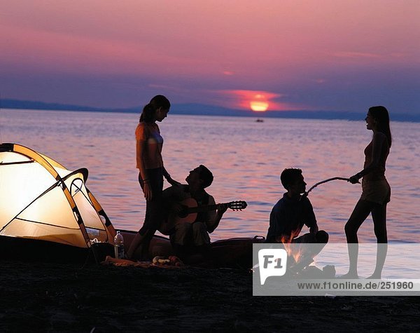 10531973  youngsters  tents  camping  campinging  camp  warehouse  food  guitar  campfire  lake  sea  lake shore  sundown  tee