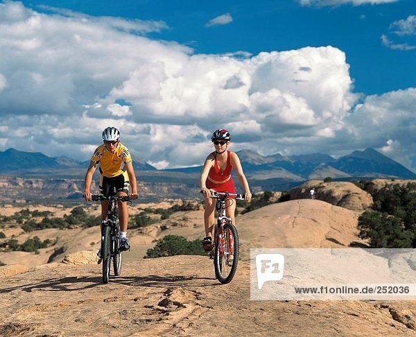 10588537  riding a bicycle  biking  riding a bike  bicycle  bike  scenery  Moab  mountain bike  pair  couple  Slickrock Trail