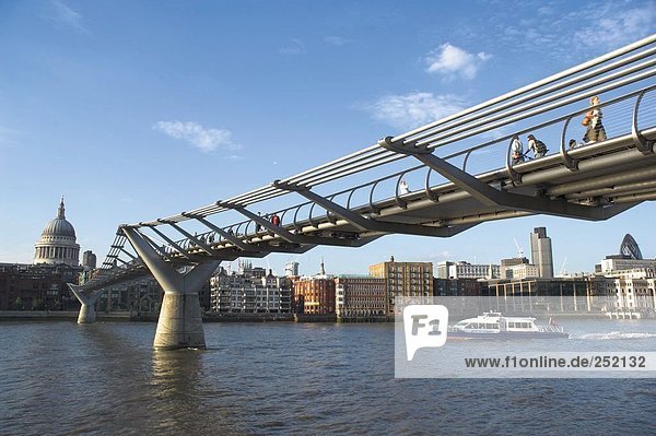 Millennium Footbridge across Thames River leading toward St Paul's cathedral  London  England