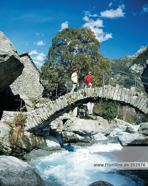 10481749  old  stone bridge  bridge  family  river  flow  child  mother  Switzerland  Europe  Ticino  Val Calneggia  walking