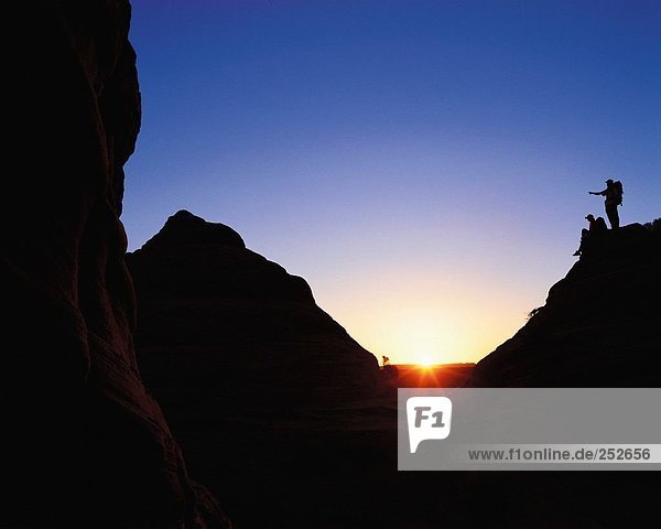 10587751  mountaineering  sport  rock  cliff  pair  couple  pariah canyon  backpacks  silhouettes  sundown  USA  America  Nort