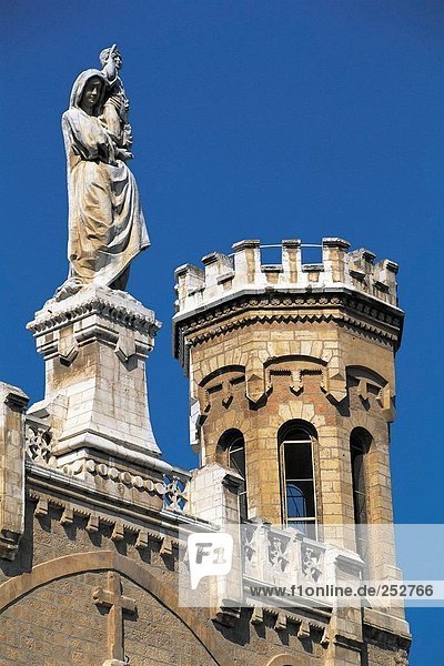 Jesus-Statue über Kirche gegen blauen Himmel