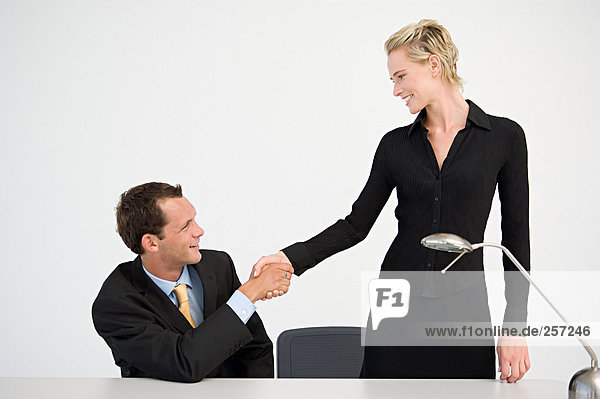 Handshake between two office workers