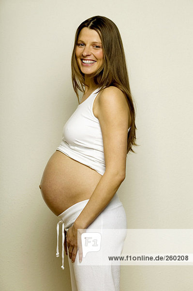 Pregnant woman smiling  side view