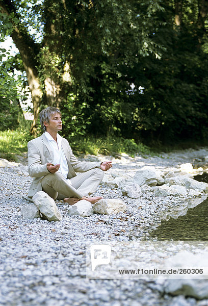 Mann am Fluss  meditierend