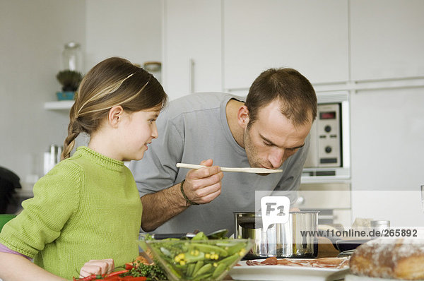 Man and girl in kitchen