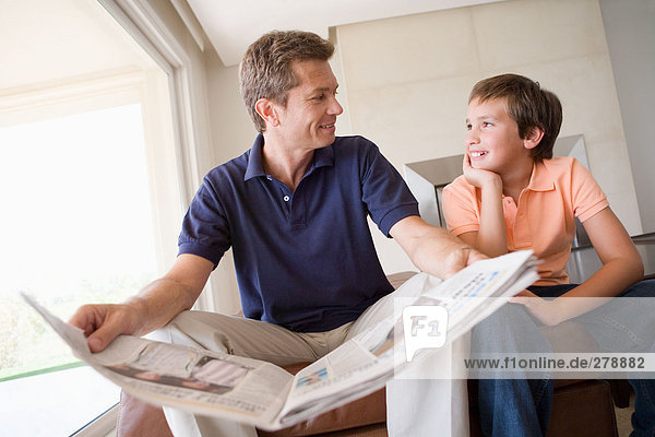 Son and father with newspaper