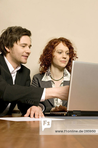 Man and woman working at office with laptop