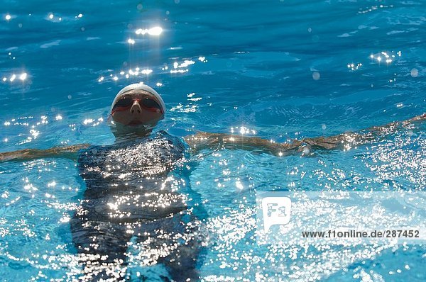 Front View of Female Swimmer Swimming Backstroke