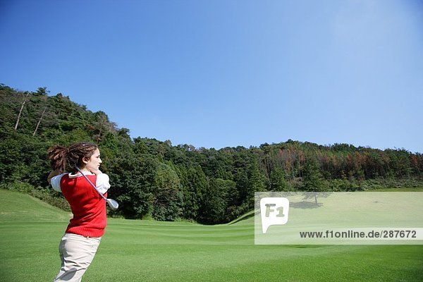 Junge Frau Golf zu spielen