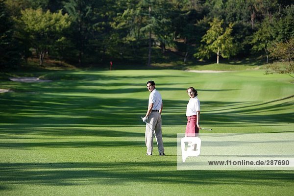 Paar stehend auf einem Golfplatz
