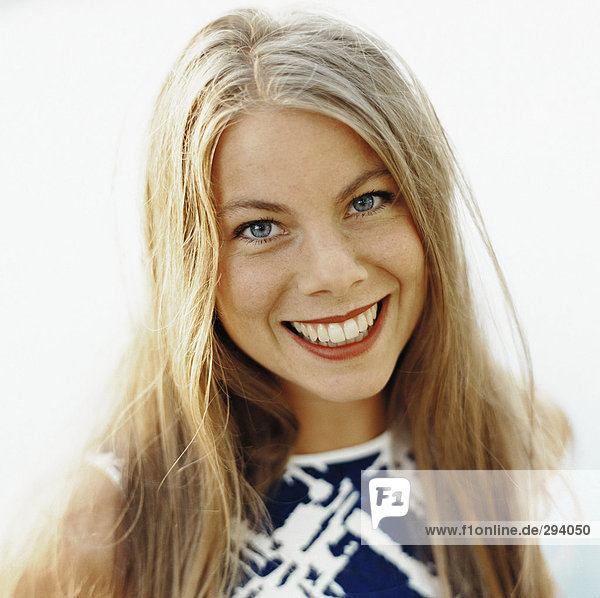 Eine Lächelnde Frau mit langen blonden Haaren Portrait.