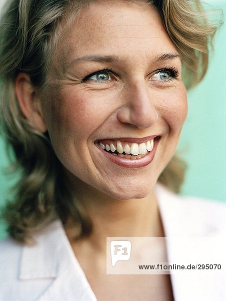 A blond woman smiling portrait close-up.