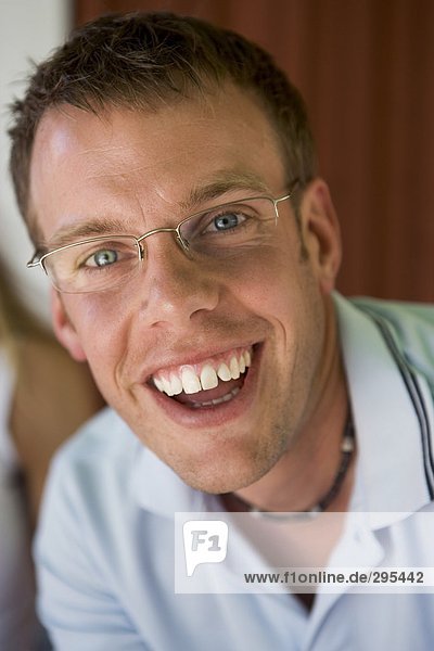 A smiling man looking at the camera portrait.