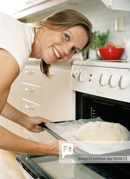 Eine Frau Brotbacken in einer Küche.