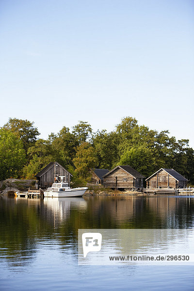 Cottages by calm water.