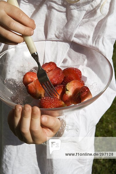 Strawberries with sugar in a bowl.