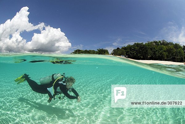 Philippines  Dalmakya Island  woman scuba diver in sea  underwater view