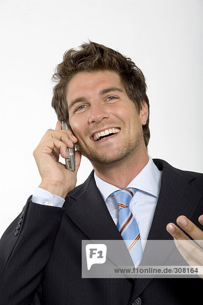 Young businessman using mobile phone  smiling  close-up
