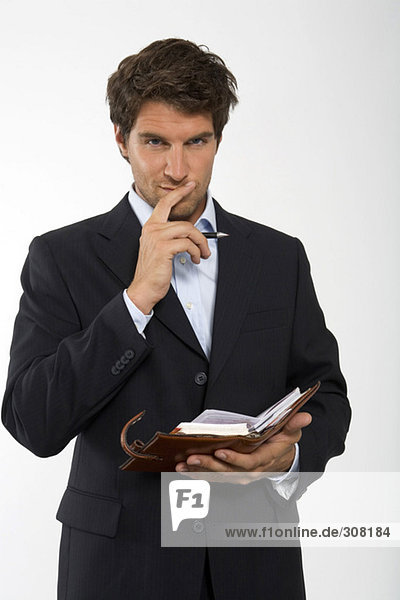 Young businessman with personal organizer  close-up  portrait